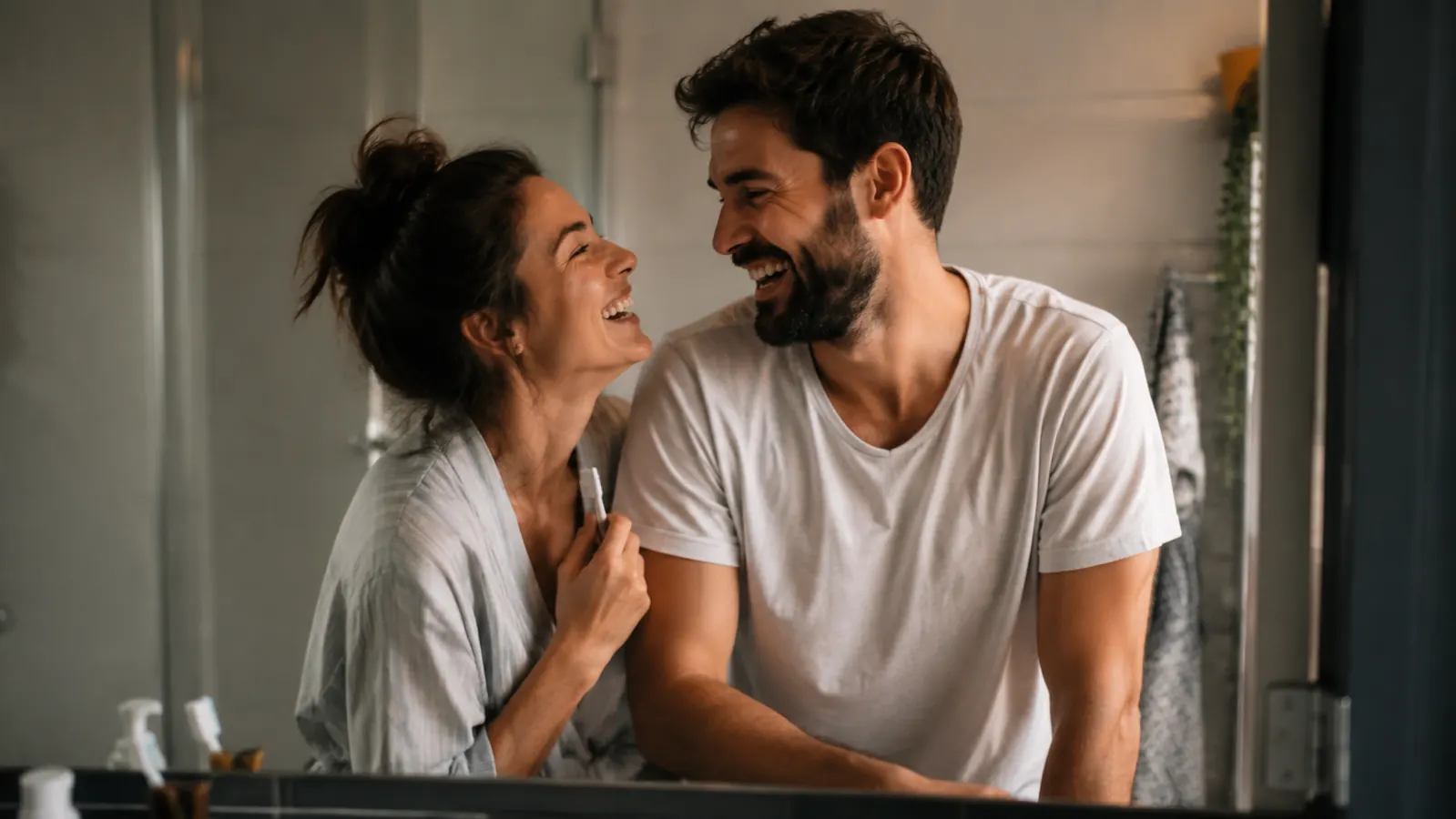 Couple smiling together in a bathroom, man's beard looking neat and well-conditioned